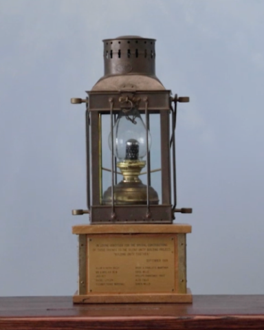 A small lantern against a grey background